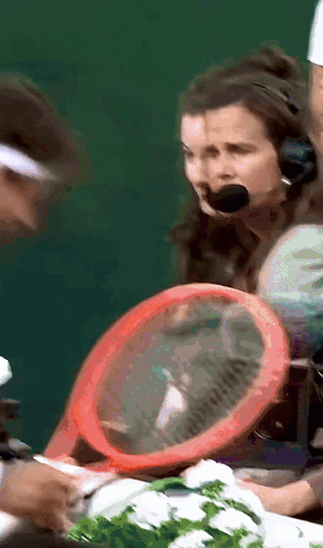 A Woman Wearing A Headset Holds A Red Racket GIF