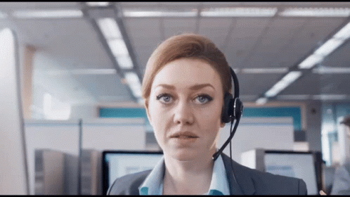A Woman Wearing A Headset Looks At The Camera With A Serious Look On Her Face GIF