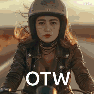 A Woman Wearing A Helmet And A Leather Jacket Is Riding A Motorcycle With The Word Otw Written On The Front GIF