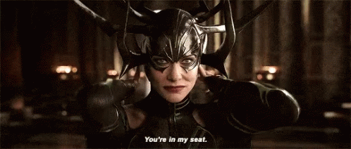 A Woman Wearing A Helmet And A Mask Is Talking To Someone . GIF