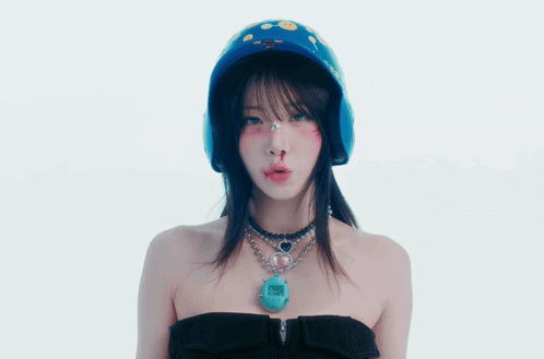 A Woman Wearing A Helmet And A Necklace With A Pendant That Says ' I Love You ' GIF