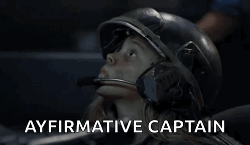 A Woman Wearing A Helmet With The Words Ayfirmative Captain Written Above Her GIF