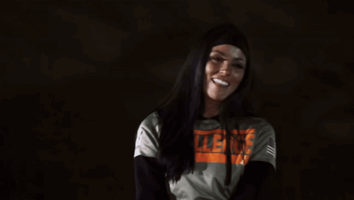 A Woman Wearing A Hoodie With The Word Violence On It . GIF