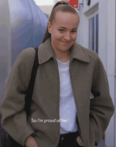 A Woman Wearing A Jacket And A White Shirt Says " So I 'M Proud Of Her " GIF