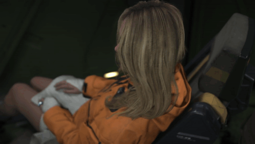 A Woman Wearing A Jacket That Says ' Ascent ' On It Is Giving A Thumbs Up GIF