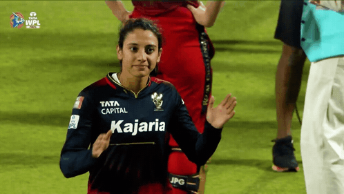 A Woman Wearing A Jersey That Says Kajaria GIF