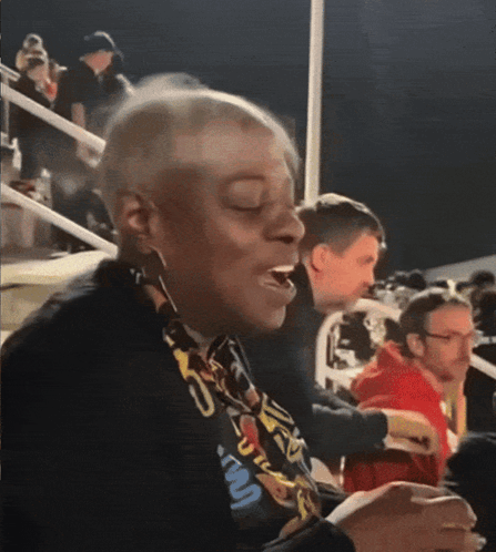 A Woman Wearing A Lanyard That Says ' U.s.a. ' On It GIF
