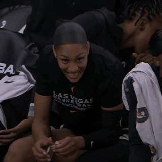 A Woman Wearing A Las Vegas Basketball Shirt Smiles GIF
