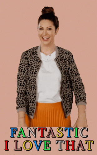 A Woman Wearing A Leopard Print Jacket And An Orange Pleated Skirt GIF