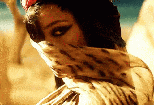 A Woman Wearing A Leopard Print Scarf Covering Her Face GIF
