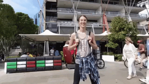 A Woman Wearing A Let 'S Set Go Tank Top GIF