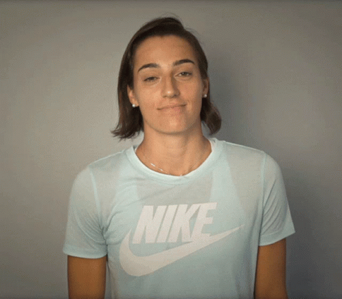 a woman wearing a light blue nike t-shirt