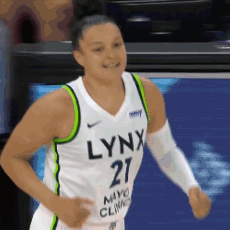 A Woman Wearing A Lynx Jersey Is Running GIF