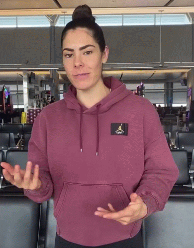 A Woman Wearing A Maroon Air Jordan Hoodie Is Talking GIF