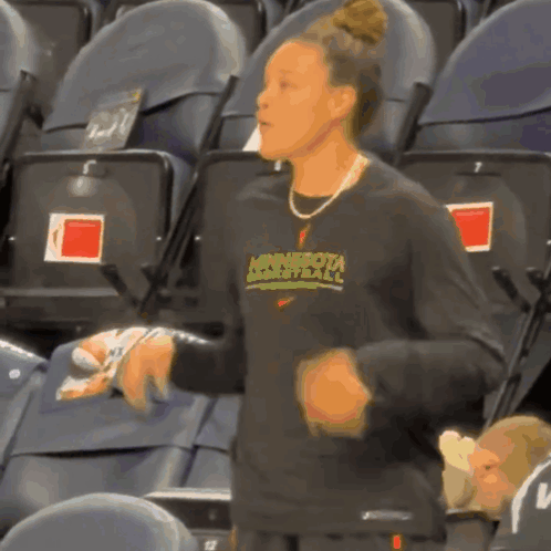 A Woman Wearing A Minnesota Basketball Shirt GIF