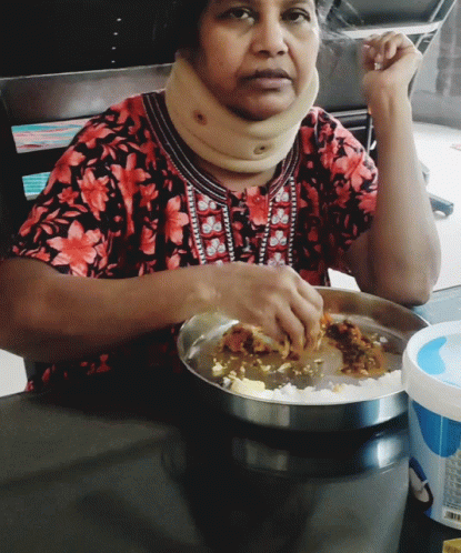 A Woman Wearing A Neck Brace Is Eating Food GIF