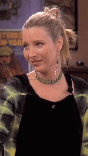 A Woman Wearing A Necklace And Hoop Earrings Stands In Front Of A Poster That Says ' Stones New York ' GIF