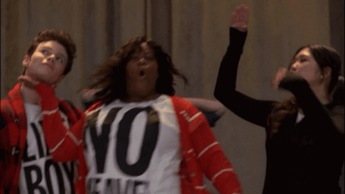 A Woman Wearing A No Weave Shirt Stands Next To A Man And A Woman GIF