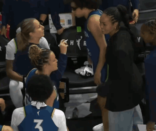 A Woman Wearing A Number 3 Jersey Talks To Another Woman GIF