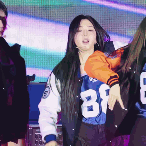 A Woman Wearing A Number 81 Jersey Is Dancing GIF