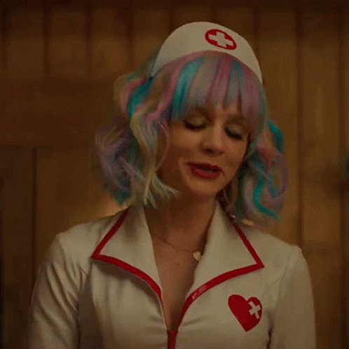 A Woman Wearing A Nurse Costume With A Red Cross On Her Hat GIF
