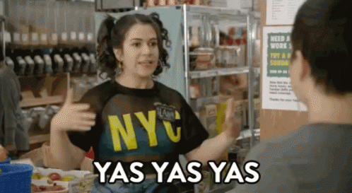 A Woman Wearing A Nyc T-Shirt Talks To Another Woman GIF