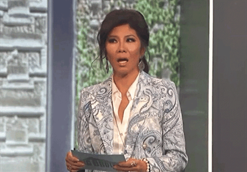 Woman In Paisley Jacket Holding Paper GIF