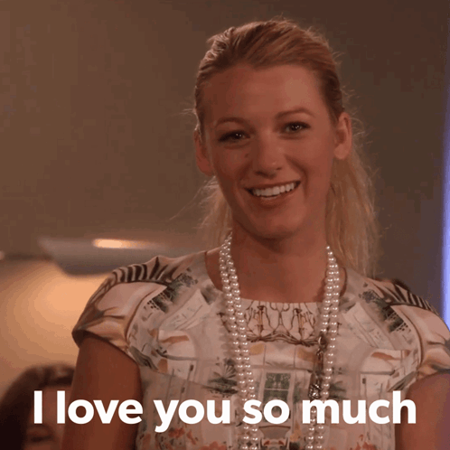 A Woman Wearing A Pearl Necklace And A Floral Shirt Says I Love You So Much GIF