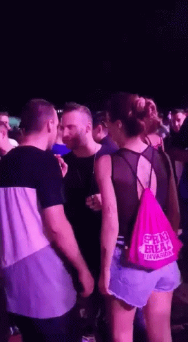 A Woman Wearing A Pink Bag That Says Shri Freak GIF