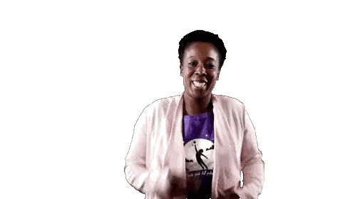 a woman wearing a pink cardigan and a purple shirt with the letter k on it is dancing