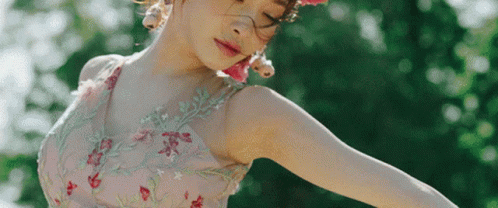A Woman Wearing A Pink Dress And A Pink Flower Crown GIF