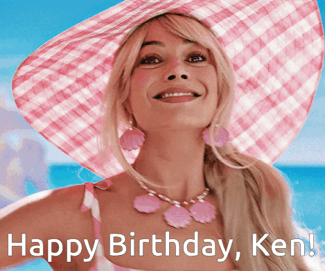 A Woman Wearing A Pink Hat And A Pink Necklace Is Smiling And Says Happy Birthday Ken GIF