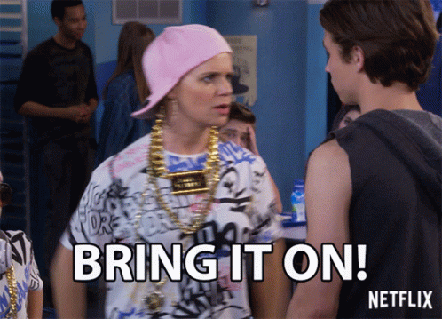 A Woman Wearing A Pink Hat And Gold Chains Says Bring It On Netflix GIF