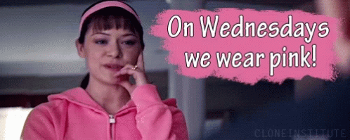A Woman Wearing A Pink Hoodie Is Talking On A Cell Phone GIF
