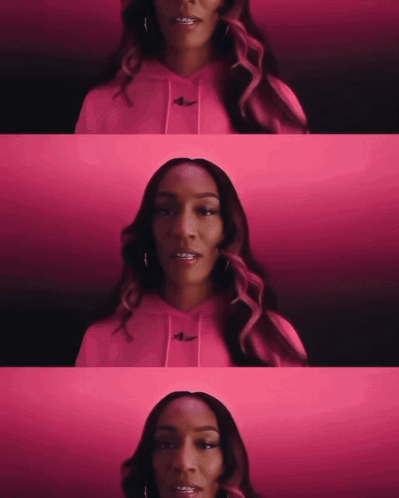 A Woman Wearing A Pink Hoodie With The Nike Logo On The Front GIF