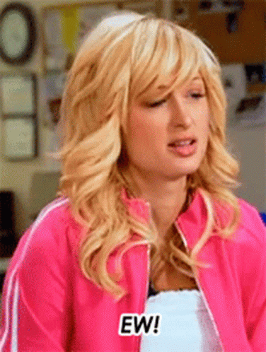 A Woman Wearing A Pink Jacket Says Ew GIF