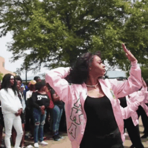 A Woman Wearing A Pink Jacket With The Letters Ka On It GIF