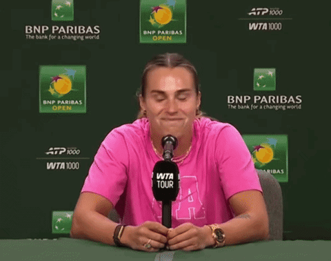 a woman wearing a pink shirt with the letter a on it