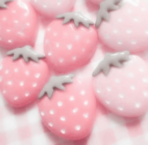 A Woman Wearing A Pink Sweater And A Butterfly Necklace GIF