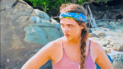 A Woman Wearing A Pink Tank Top And A Blue Headband GIF