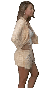 a woman wearing a plaid jacket and shorts is smiling