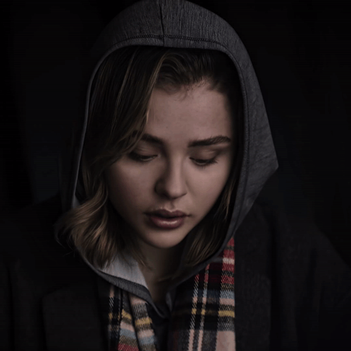 A Woman Wearing A Plaid Scarf And A Hoodie GIF