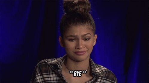 A Woman Wearing A Plaid Shirt And A Bye Necklace GIF
