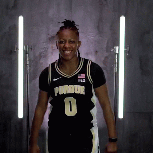 a woman wearing a purdue jersey number 0