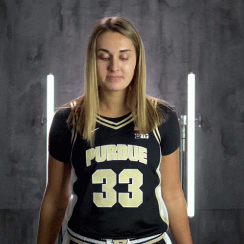 a woman wearing a purdue jersey with the number 33