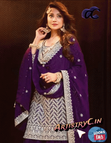 A Woman Wearing A Purple And Silver Dress With Artistry In Looks Faq GIF