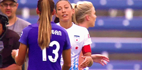 A Woman Wearing A Purple Jersey With The Number 13 On It GIF