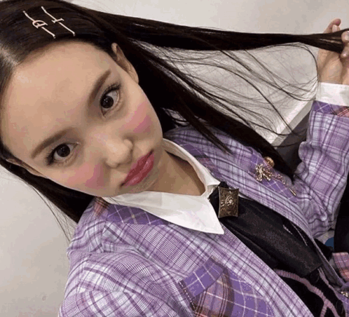 A Woman Wearing A Purple Plaid Shirt And Tie Takes A Picture Of Herself GIF