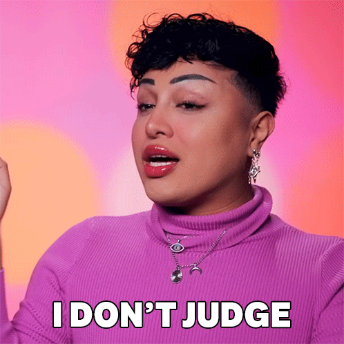 A Woman Wearing A Purple Sweater And Necklace Says I Don 'T Judge GIF