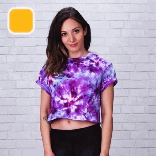 A Woman Wearing A Purple Tie Dye Crop Top GIF